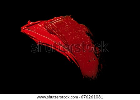 Smudged red burgundy dark lipstick isolated on black background