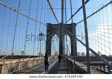 Brooklyn Bridge in the winter surrounded by blue sky