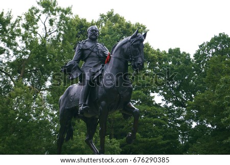 Man On Horse Metal Statue In Park