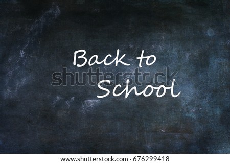 Dusty school chalkboard or blackboard with Back to school text.