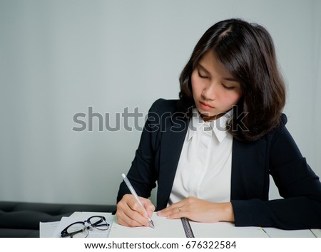 business woman writing  notebook on white background / working concept   