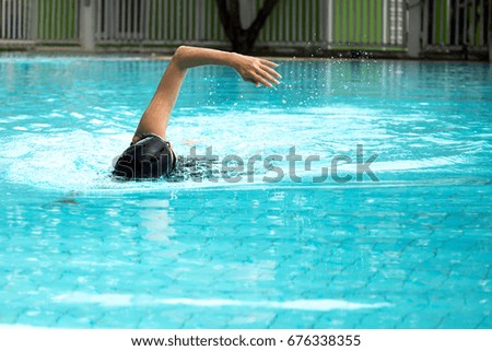 Women exercise doing swimming in the pool outdoors