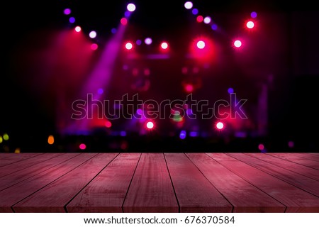 top desk with light bokeh in concert blur background,red wooden table Royalty-Free Stock Photo #676370584