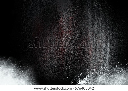 Abstract design of white powder cloud against dark background.