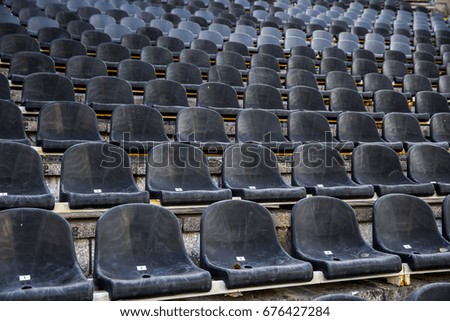 Empty tribune with black seat on soccer stadium