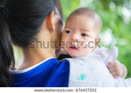 Cute newborn asian baby, Mother carrying baby