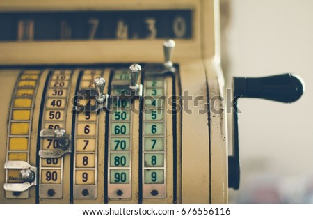 Old cash register machine Royalty-Free Stock Photo #676556116