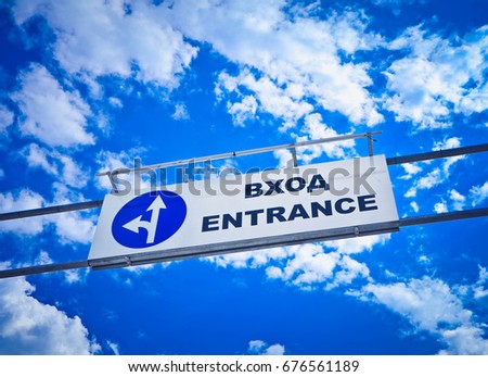 Entrance direction sign translated to Bulgarian language, Europe, Bulgaria. Entrance road sign on the background of blue cloudy sky.