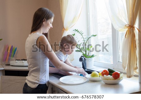 kitchen mom son wash fruits and vegetables