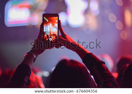 Women take a picture with telephone in night party