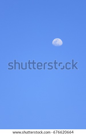 Clear blue sky which has half moon in daytime (can used as background)