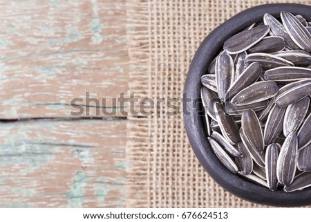 pile of sunflower seeds on wooden background
