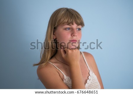Woman thinks on a blue background