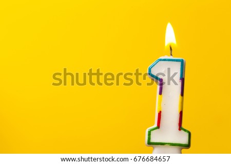 Number 1 birthday celebration candle against a bright yellow background Royalty-Free Stock Photo #676684657