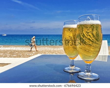 Two cold beers on the beach with a girl