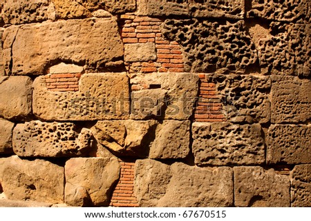 Detail of Roman wall in the city of Barcelona. Background picture
