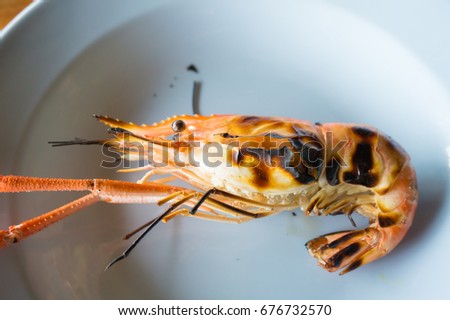 Shrimp cooked as food by burning.