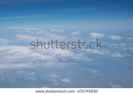 White clouds and blue sky view from airplane window. Beautiful cloudscape from sky aerial view 