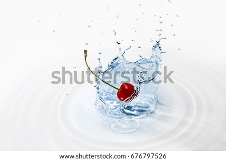 A splash of clean water with a blue tint. Cherry falling into the water