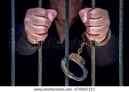 A man is imprisoned in a prison
 Royalty-Free Stock Photo #676805311
