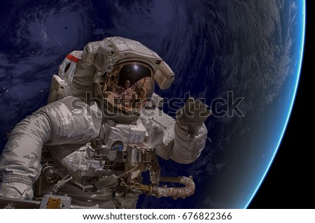 Astronaut in outer space. Nebula on the background. Elements of this image furnished by NASA.