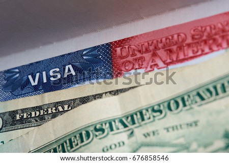American visa in passport with dollars currency close-up