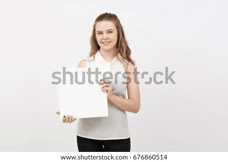 Young woman holding blank poster.Smiling woman sign board holding. Girl showing banner with copy space.