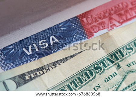 Macro of visa stamp of united state of america covered with paper dollars