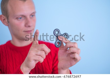 Male hand holding popular fidget spinner toy