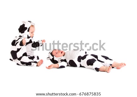 Two babes in a fancy dress cow costume on white background