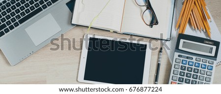 Office desk table with computer, tablet, supplies and calculator. Top view with copy space