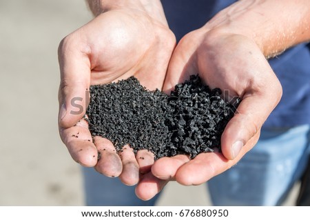 Rubber crumb in the hands of man. Royalty-Free Stock Photo #676880950