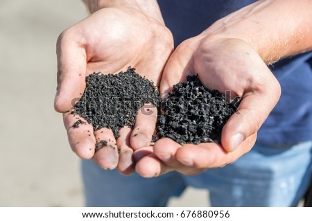 Rubber crumb in the hands of man. Royalty-Free Stock Photo #676880956