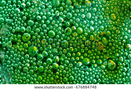 The photo a close up of abstract art glass with bubbles of green color in beams of the sun. Glass abstract background. Pattern. Glass abstract. Modern Art  deco. Decor glass. 