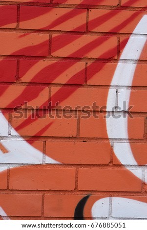 Orange, Red, and White Spray Paint on Brick