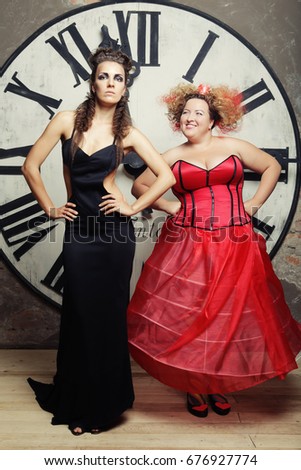 Two Queens posing next to the clock. Holiday picture.