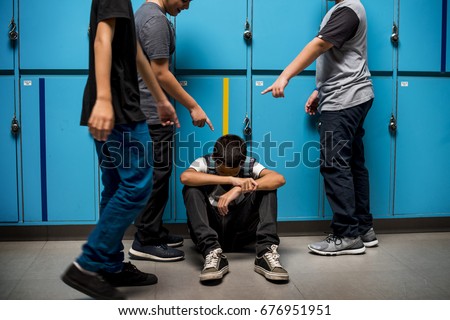 Boy student getting bullied in school Royalty-Free Stock Photo #676951951