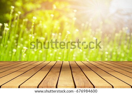 Perspective wooden table on top over blur natural background, can be used mock up for montage products display or design layout.