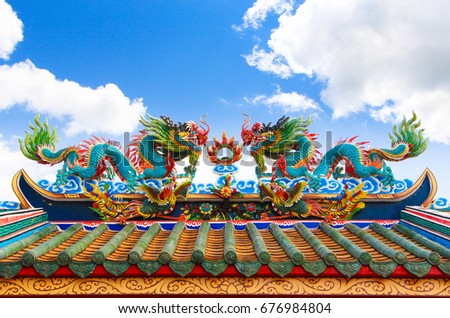 Chinese dragon statues on roof of Chinese temple in Thailand and beautiful sky background 