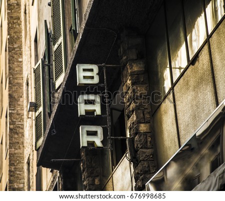 Bar text on a wall. It is bar sign in Rome, Italy. bar old retro vintage aged sign on dark facade and building in Europe. business background