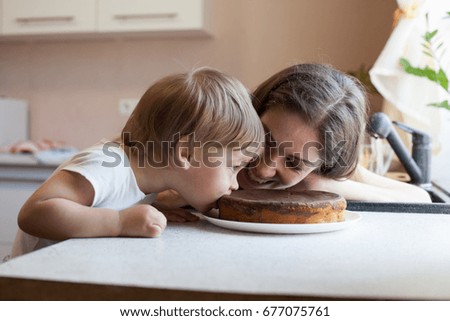 mother and son eating pie in the kitchen