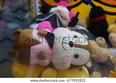 Close up of Japanese claw crane game machine soft toys and cuddly bears at the game centre