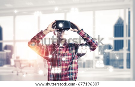 Young man with virtual reality headset or 3d glasses over connection background . Mixed media