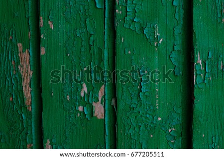 Old wooden green rustic background with peeling paint, texture
