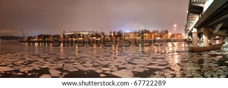 Night panorama of the winter river and a big sports arena of the Olympic Complex Luzhniki, Moscow, Russia