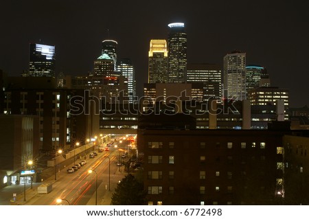 Minneapolis city skyline at night with street and moving cars