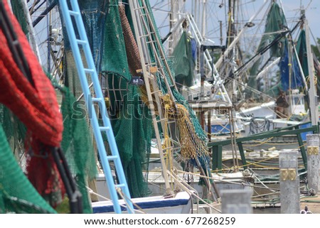 several shrimp boat nets, rigging and masts docked, full frame