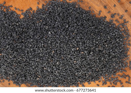 sesame seeds and oil on wood background