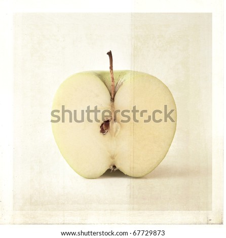 Apple cut in half with textured background