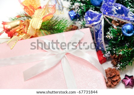 Beautiful pink gift box under a christmas tree